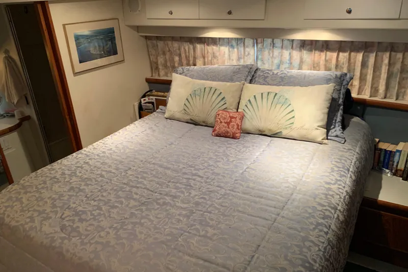 Slide: The Image of Cozy bedroom in 1994 Carver 440 Aft Cabin Motor Yacht with elegant bedding and decor. - 31