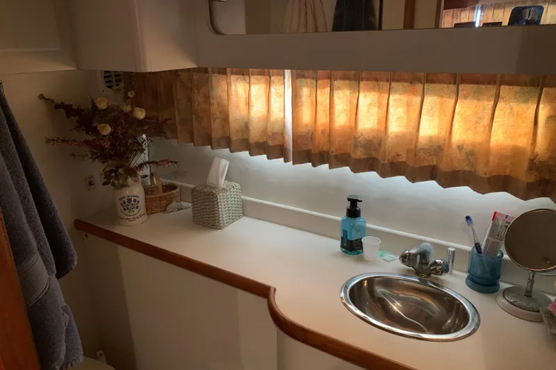 Slide: The Image of Bathroom interior of 1994 Carver 440 Aft Cabin Motor Yacht with sink and decor. - 34