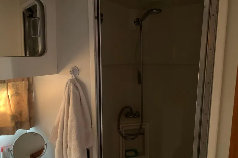 Slide: The Image of Bathroom interior of 1994 Carver 440 Aft Cabin Motor Yacht with shower and towel. - 35