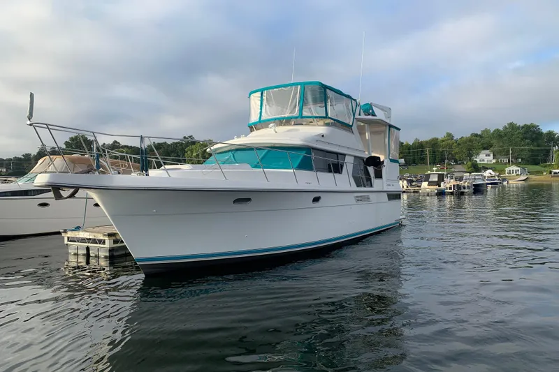 Slide: The Image of 1994 Carver 440 Aft Cabin Motor Yacht docked on calm water. - 37