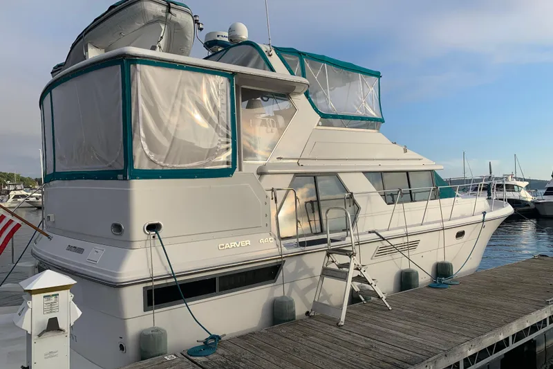 Slide: The Image of 1994 Carver 440 Aft Cabin Motor Yacht docked at marina, side view. - 4