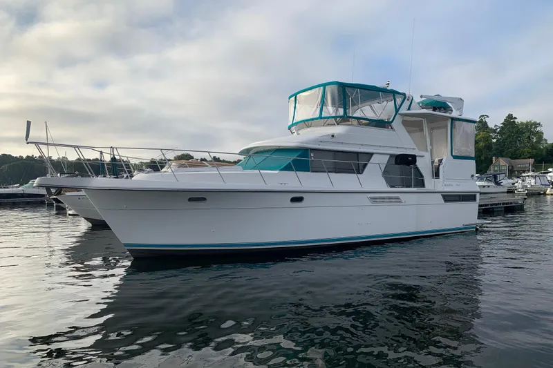 Slide: The Image of 1994 Carver 440 Aft Cabin Motor Yacht docked on calm water. - 41