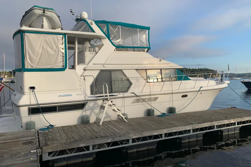 Slide: The Image of 1994 Carver 440 Aft Cabin Motor Yacht docked at marina, side view. - 6