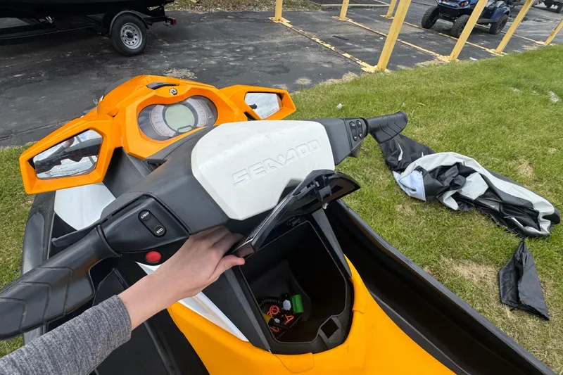 Slide: The Image of 2018 Sea-Doo GTI SE 155 jet ski with orange dashboard and storage compartment. - 10