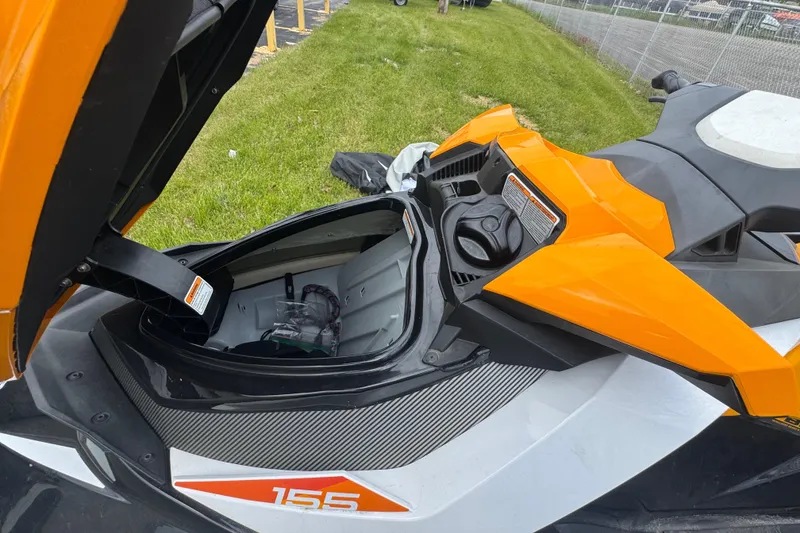 Slide: The Image of 2018 Sea-Doo GTI SE 155 with open storage compartment, parked on grass. - 9