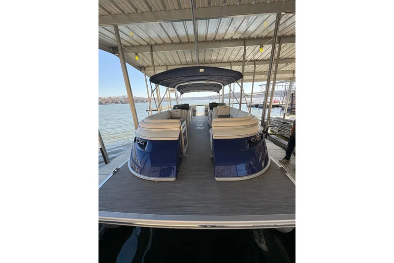 Slide: The Image of 2023 Bennington QX 30 QXFBWA X2 Wide Beam pontoon boat docked under a canopy. - 15