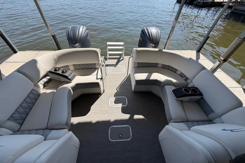 Slide: The Image of 2023 Bennington QX 30 pontoon boat interior with plush seating and cup holders. - 19