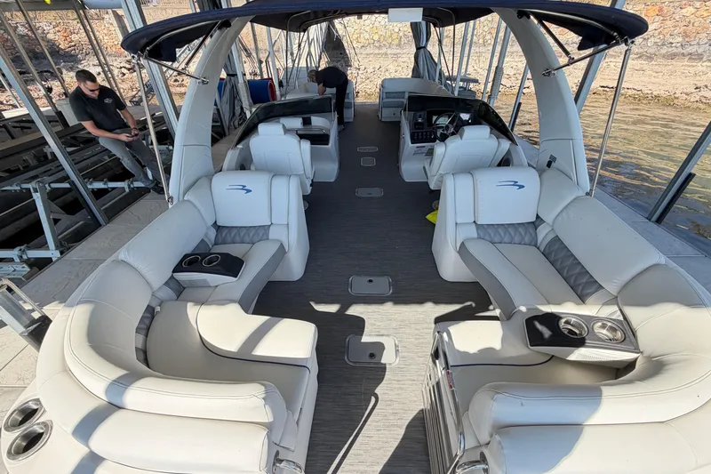 Slide: The Image of 2023 Bennington QX 30 pontoon boat interior with luxurious seating and modern design. - 22