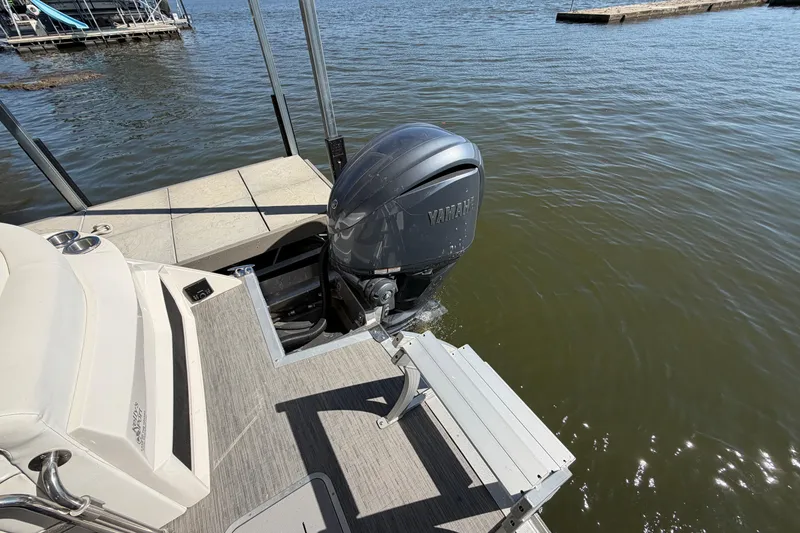 Slide: The Image of 2023 Bennington QX 30 boat with Yamaha outboard motor on a lake. - 29