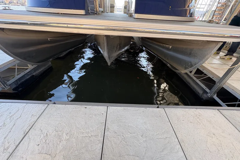 Slide: The Image of 2023 Bennington QX 30 QXFBWA X2 Wide Beam pontoon boat on a lift. - 3