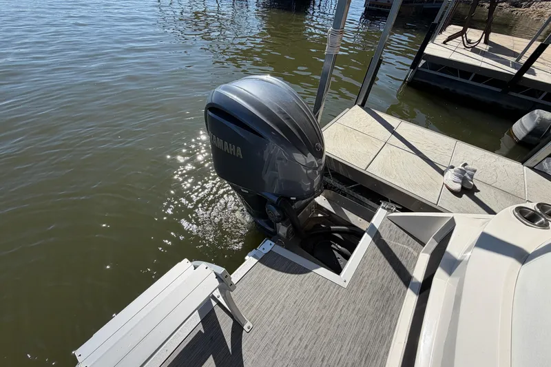 Slide: The Image of 2023 Bennington QX 30 boat with Yamaha outboard motor at dock. - 30