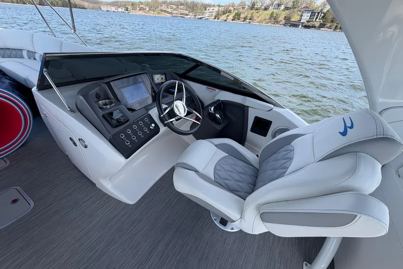 Slide: The Image of 2023 Bennington QX 30 boat helm with modern controls and luxurious seating. - 37