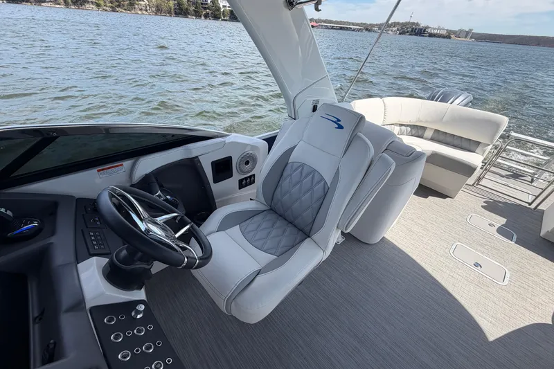 Slide: The Image of 2023 Bennington QX 30 QXFBWA X2 boat interior with luxury seating and steering wheel. - 38