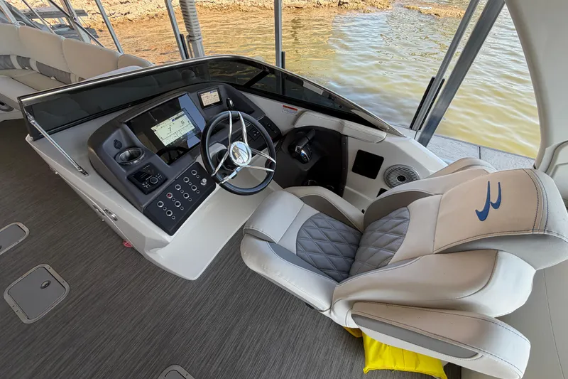Slide: The Image of 2023 Bennington QX 30 boat helm with modern controls and luxurious seating. - 7