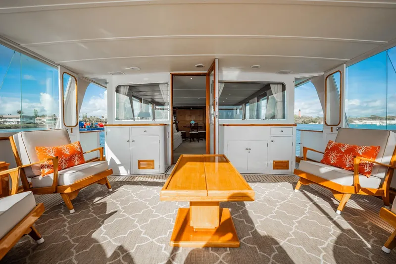 Slide: The Image of Luxurious 1972 Trumpy 72 Motor Yacht deck with elegant seating and scenic views. - 10