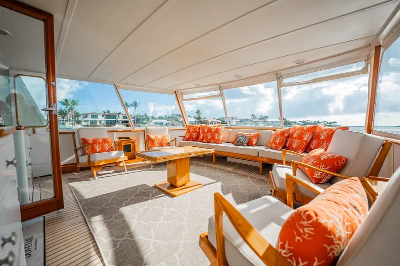 Slide: The Image of Luxurious 1972 Trumpy 72 Motor Yacht interior with orange cushions and panoramic windows. - 11