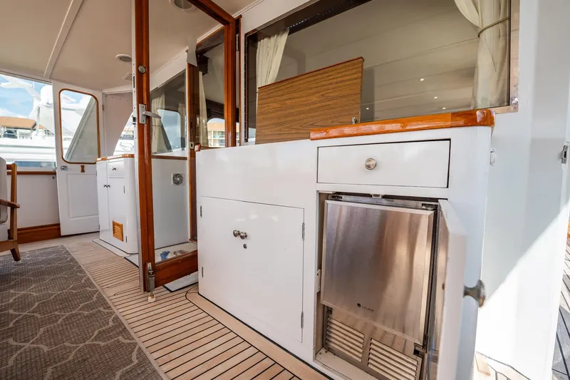 Slide: The Image of Interior view of a 1972 Trumpy 72 Motor Yacht, featuring wooden accents and modern amenities. - 13