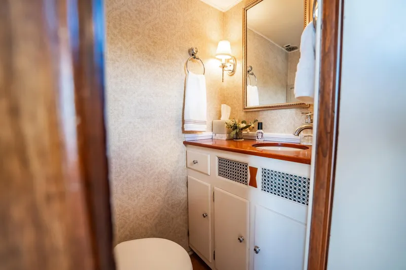 Slide: The Image of Elegant bathroom interior on 1972 Trumpy 72 Motor Yacht, featuring wooden accents and classic decor. - 20