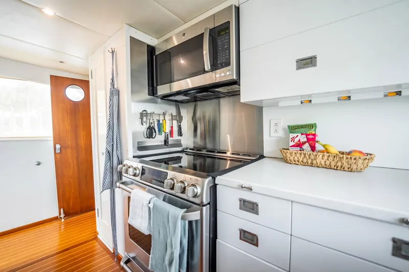 Slide: The Image of Modern kitchen interior on 1972 Trumpy 72 Motor Yacht with stainless steel appliances. - 22