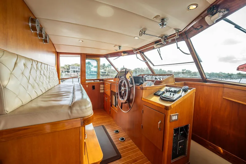 Slide: The Image of Interior of 1972 Trumpy 72 Motor Yacht with wooden helm and seating area. - 24