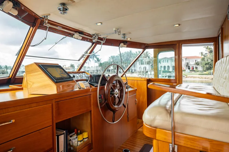 Slide: The Image of Interior of 1972 Trumpy 72 Motor Yacht with wooden helm and plush seating. - 25