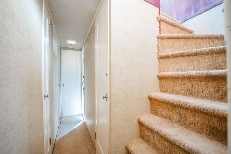 Slide: The Image of Narrow hallway and carpeted stairs inside a 1972 Trumpy 72 Motor Yacht. - 26
