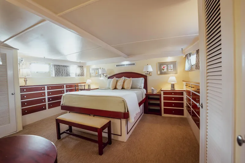 Slide: The Image of Luxurious bedroom interior on a 1972 Trumpy 72 Motor Yacht with elegant furnishings. - 27