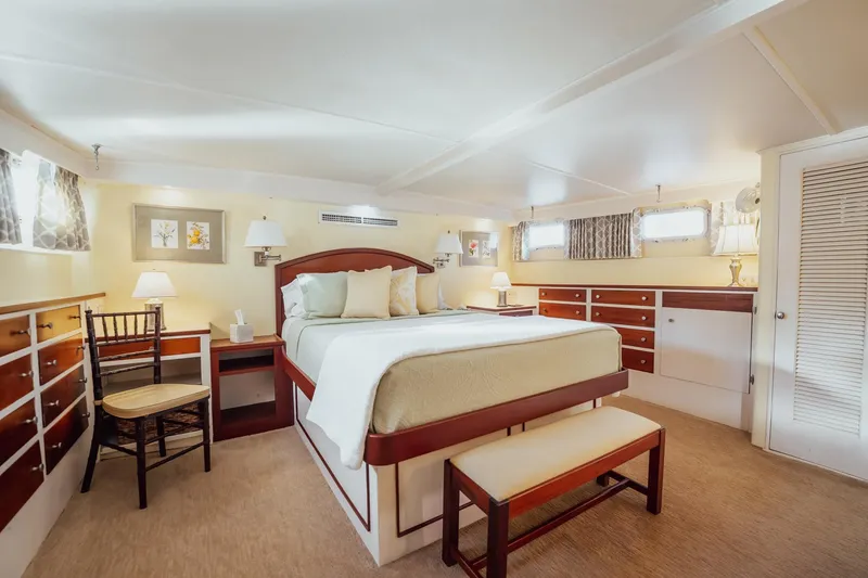 Slide: The Image of Luxurious bedroom interior of 1972 Trumpy 72 Motor Yacht with elegant furnishings and soft lighting. - 28