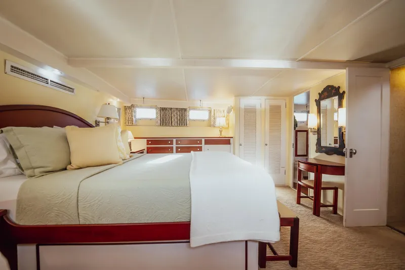 Slide: The Image of Luxurious bedroom interior on a 1972 Trumpy 72 Motor Yacht, featuring elegant furnishings. - 29