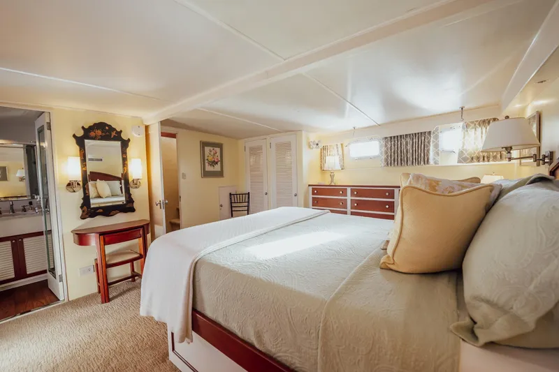 Slide: The Image of Luxurious bedroom interior of 1972 Trumpy 72 Motor Yacht with elegant decor and natural light. - 30