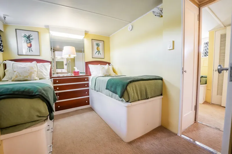 Slide: The Image of Twin bedroom in 1972 Trumpy 72 Motor Yacht with pineapple artwork and green bedding. - 35