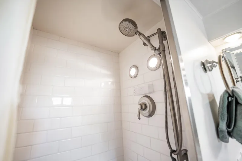 Slide: The Image of Shower area in 1972 Trumpy 72 Motor Yacht with white tiles and modern fixtures. - 36