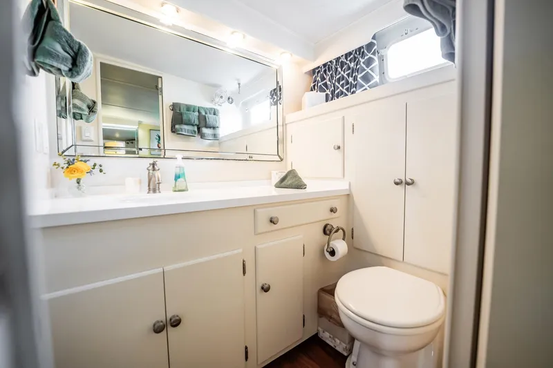 Slide: The Image of Bathroom interior of 1972 Trumpy 72 Motor Yacht with white cabinetry and mirror. - 37
