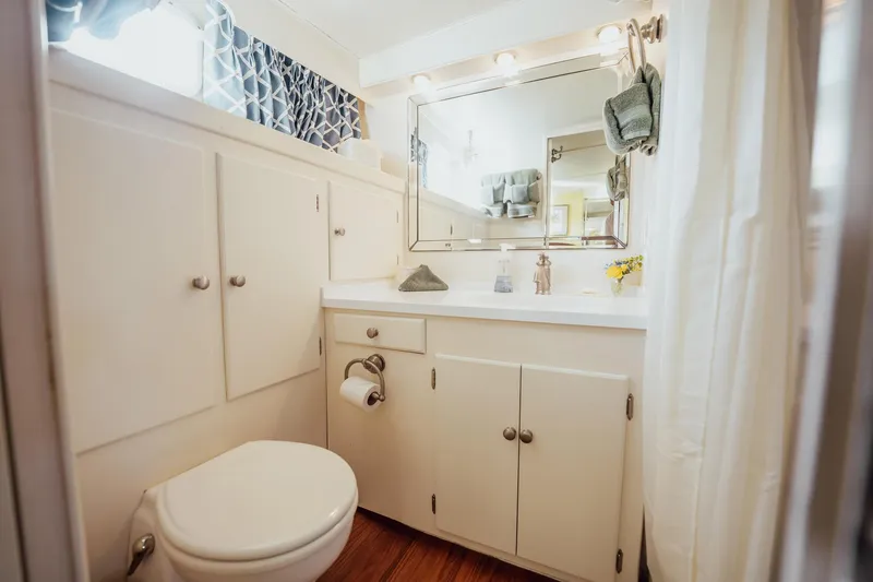 Slide: The Image of Bathroom interior of 1972 Trumpy 72 Motor Yacht with white cabinetry and mirror. - 38