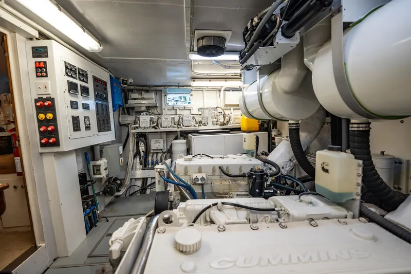 Slide: The Image of Engine room of a 1972 Trumpy 72 Motor Yacht with Cummins engines and control panels. - 42