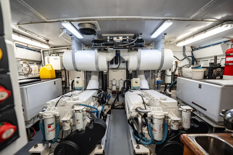Slide: The Image of Engine room of a 1972 Trumpy 72 Motor Yacht, featuring dual engines and equipment. - 45