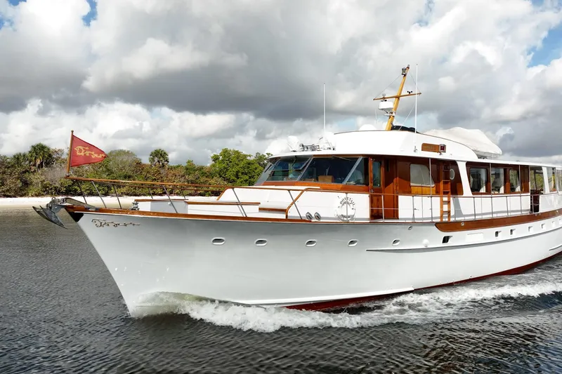 Slide: The Image of 1972 Trumpy 72 Motor Yacht cruising on water under cloudy skies. - 5