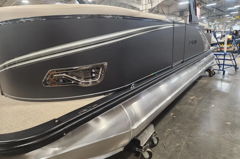 The Image of 2026 Avalon LSZ Quad Lounge Tri Log pontoon boat in a factory setting. - 0