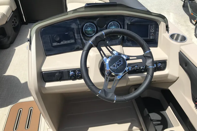Slide: The Image of Steering console of 2026 Avalon LSZ Quad Lounge Tri Log boat with modern controls. - 18
