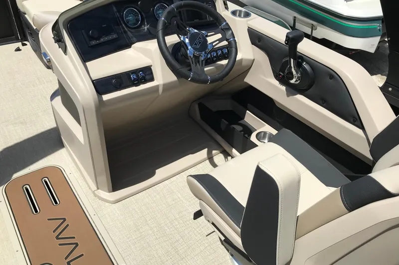 Slide: The Image of Interior view of 2026 Avalon LSZ Quad Lounge Tri Log boat cockpit with steering wheel. - 19
