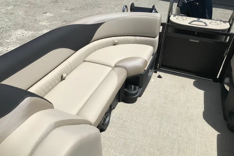 Slide: The Image of 2026 Avalon LSZ Quad Lounge Tri Log boat interior with beige seating and cup holders. - 21