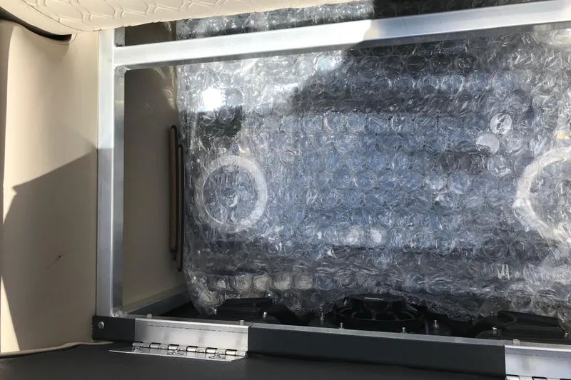 Slide: The Image of Bubble-wrapped component inside 2026 Avalon LSZ Quad Lounge Tri Log boat compartment. - 24