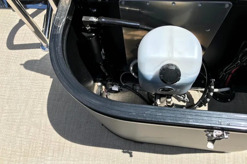 Slide: The Image of Storage compartment of 2026 Avalon LSZ Quad Lounge Tri Log boat, featuring a fluid container. - 31