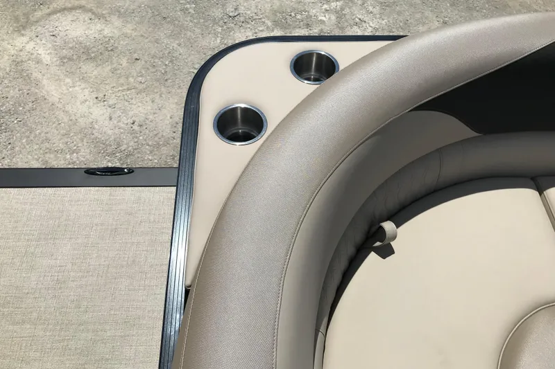 Slide: The Image of 2026 Avalon LSZ Quad Lounge Tri Log boat interior with cup holders and beige seating. - 33