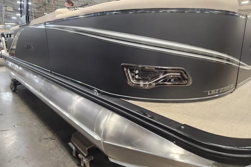 Slide: The Image of 2026 Avalon LSZ QUAD LOUNGE TRI LOG pontoon boat in a showroom setting. - 4