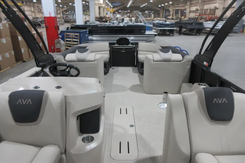 Slide: The Image of 2026 Avalon LSZ Quad Lounge Tri Log boat interior with plush seating in a showroom. - 5