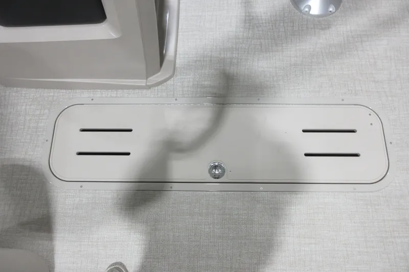 Slide: The Image of 2026 Avalon LSZ Quad Lounge Tri Log floor compartment with sleek design and secure latch. - 7