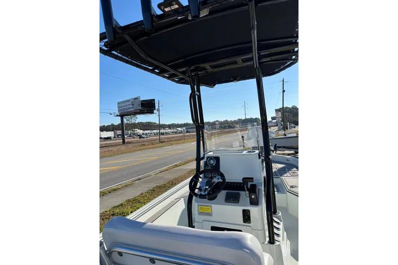 Slide: The Image of 2026 Excel 230 Bay Pro Elite boat console with steering wheel and controls. - 10