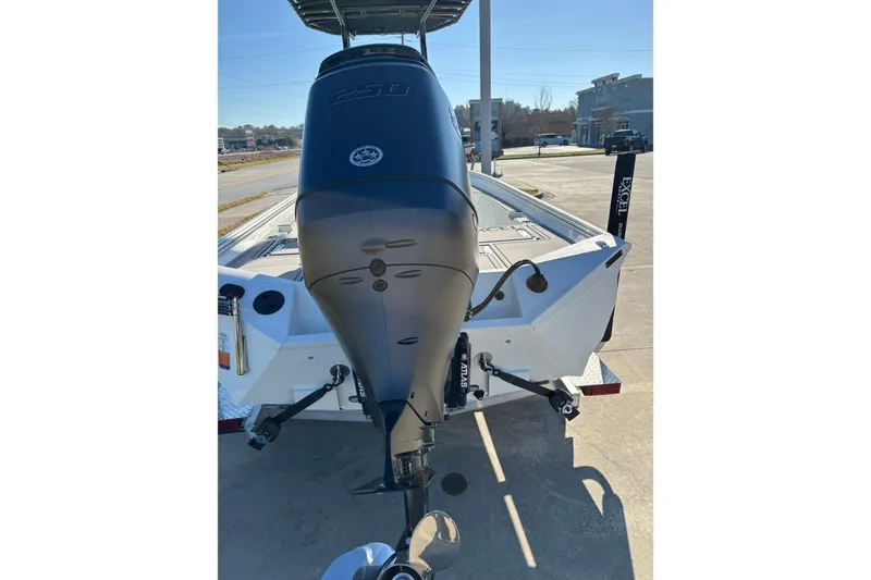 Slide: The Image of 2026 Excel 230 Bay Pro Elite boat with powerful outboard motor, parked outdoors. - 11