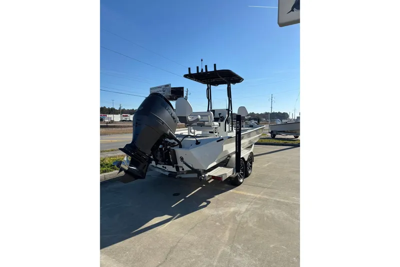 Slide: The Image of 2026 Excel 230 Bay Pro Elite boat with outboard motor on trailer. - 9
